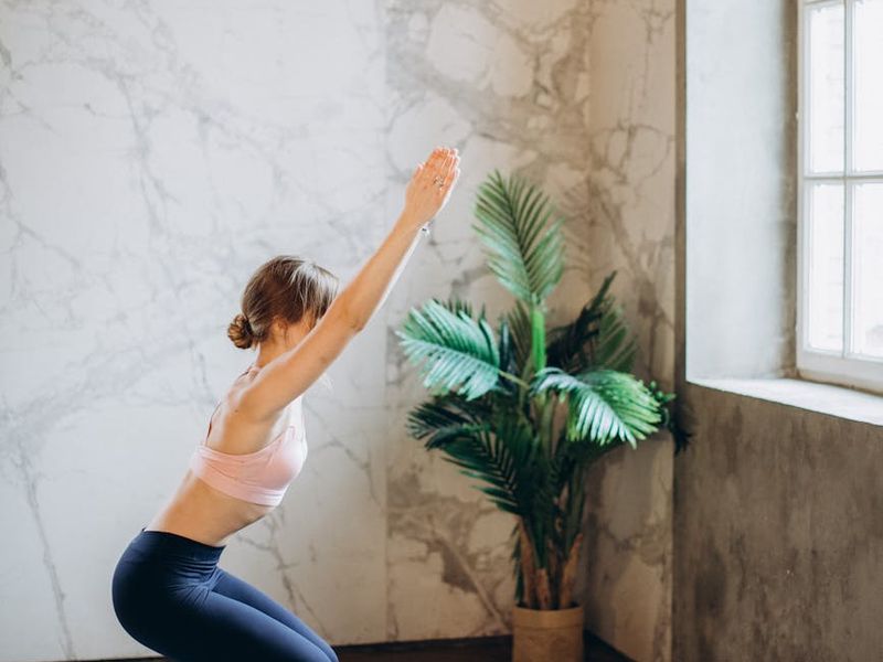 Main yoga practice area with natural lighting and plants.